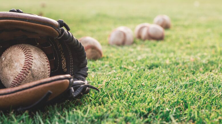 white baseball ball on brown leather baseball mitt