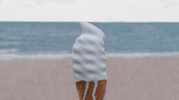 person holding vanilla ice cream on cone