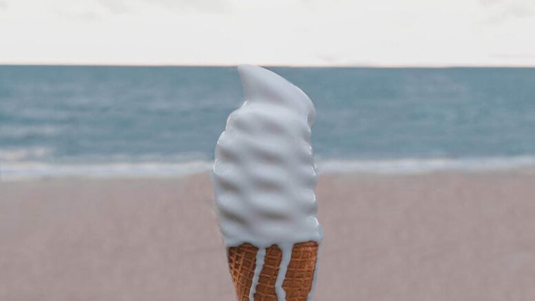 person holding vanilla ice cream on cone