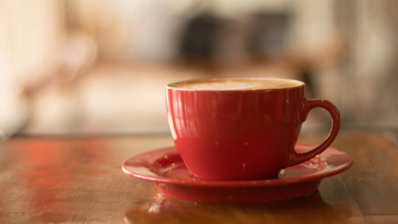 red ceramic mug on red saucer